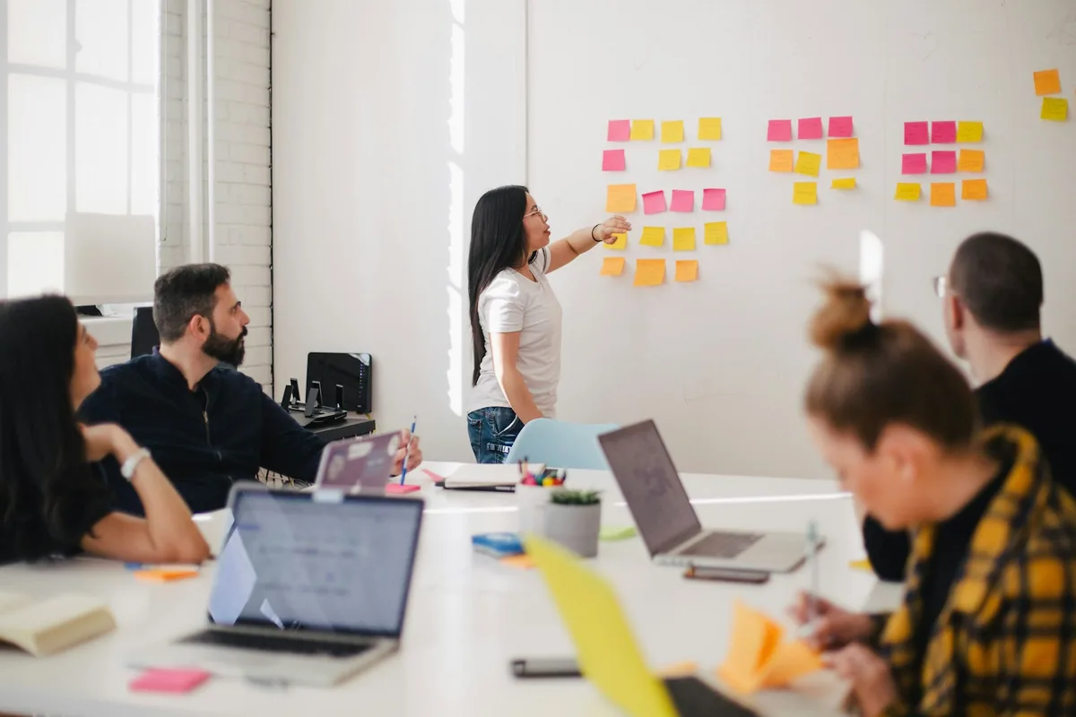 Team mapping brand ideas across sticky notes and sketches